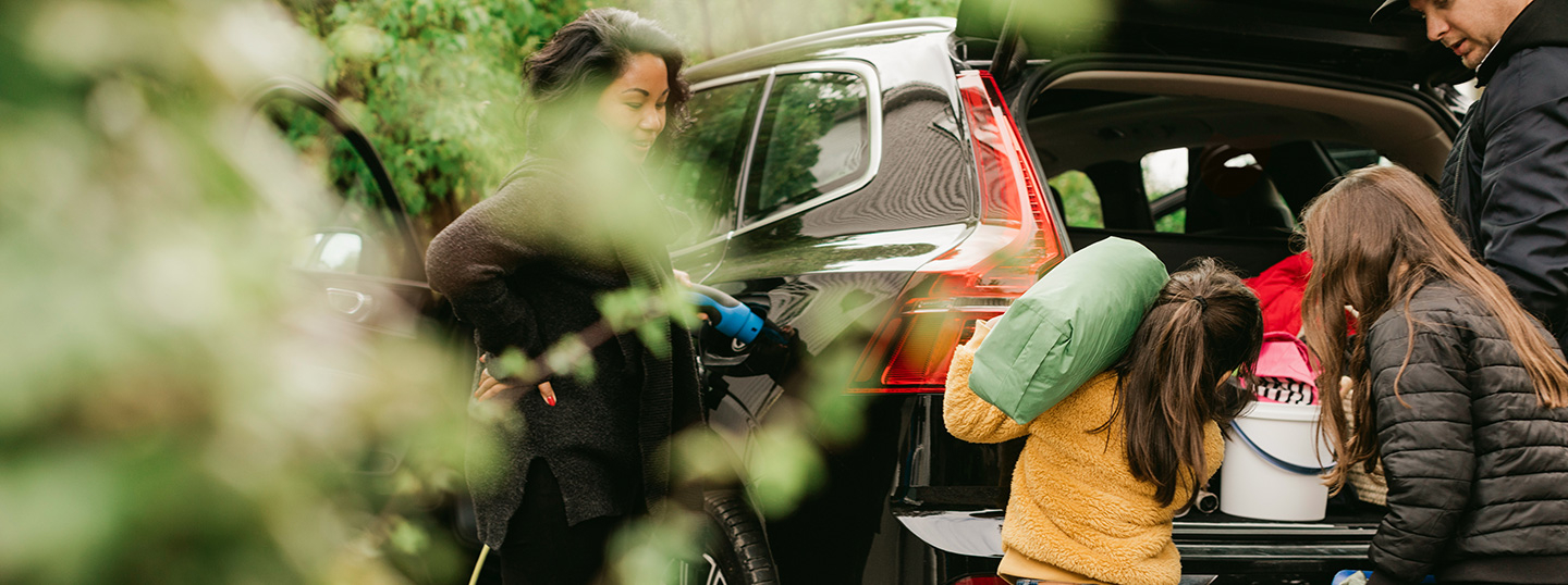 Family loading up their electric car for a trip