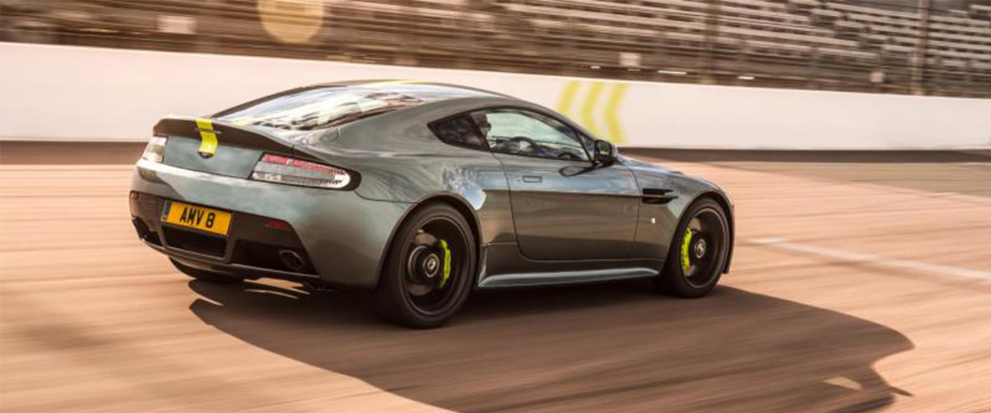 Silver aston martin on race track