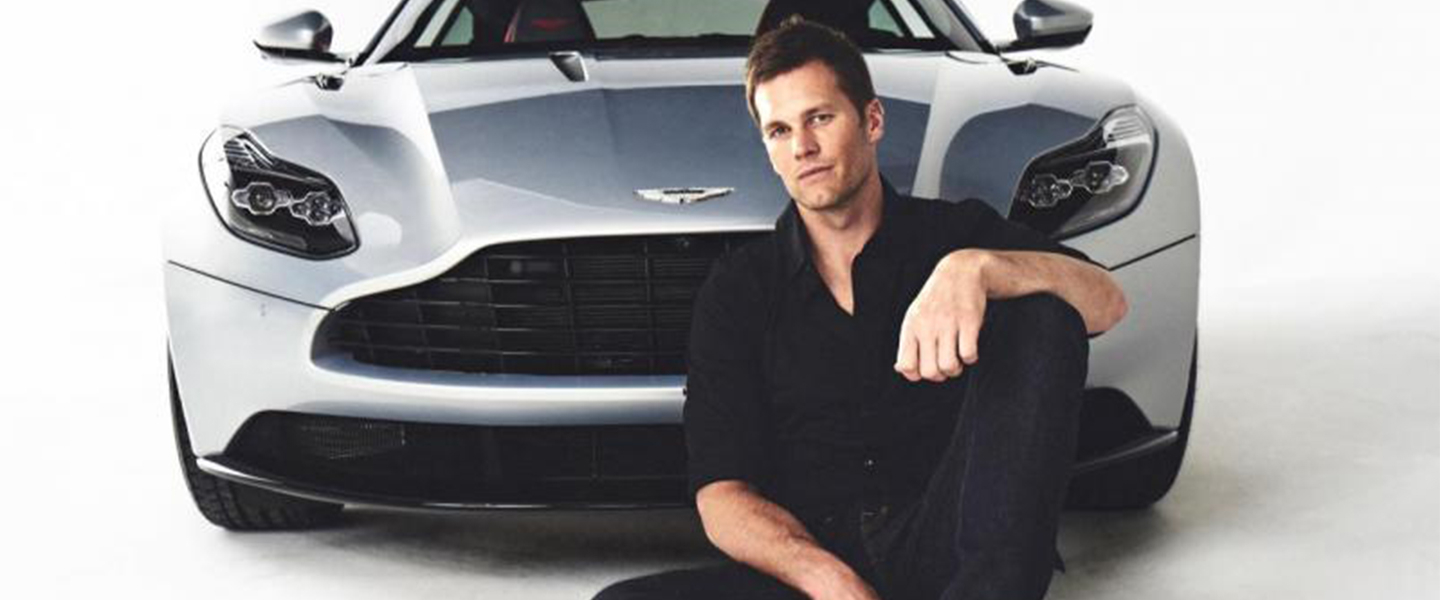 Man sitting in front of a car